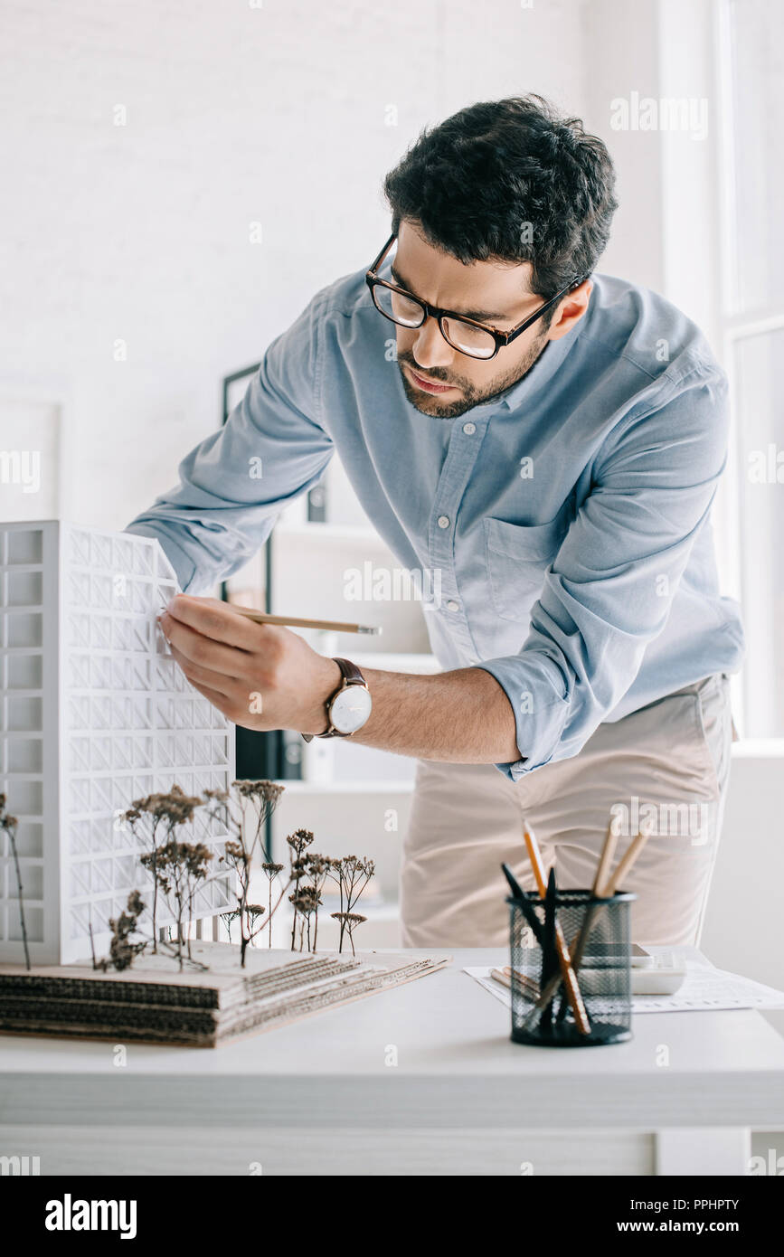 handsome architect working with architecture model on table in office Stock Photo