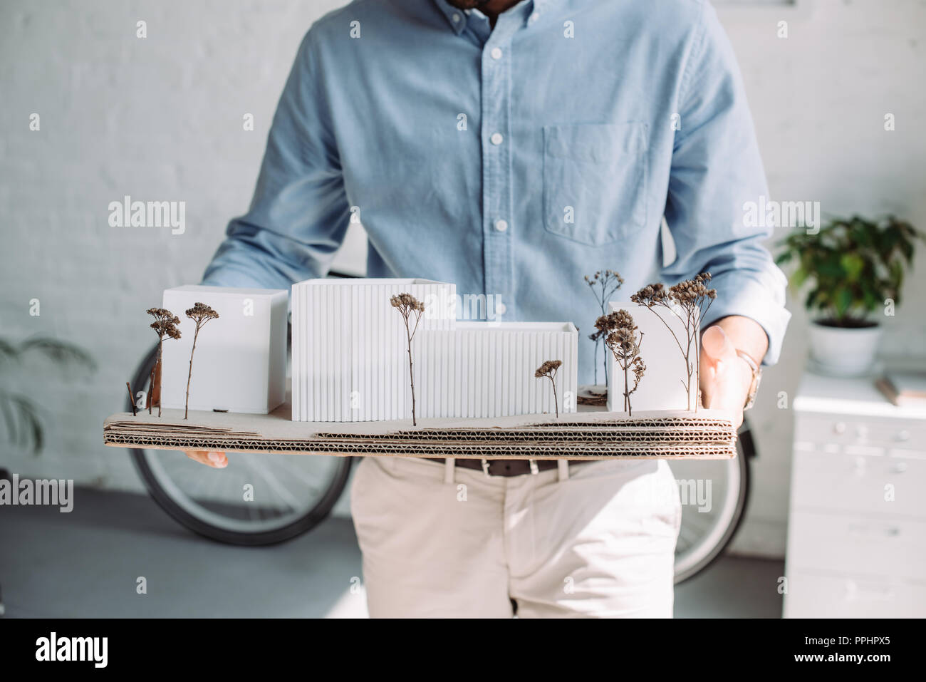 cropped image of architect holding architecture model in office Stock Photo