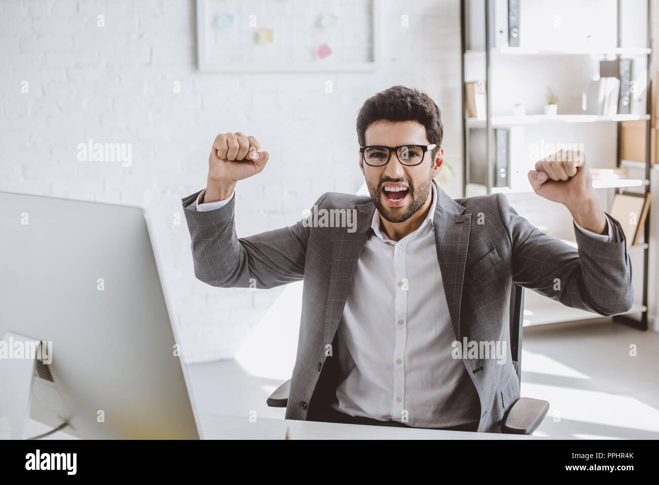 excited handsome businessman screaming and showing yes gesture in ...