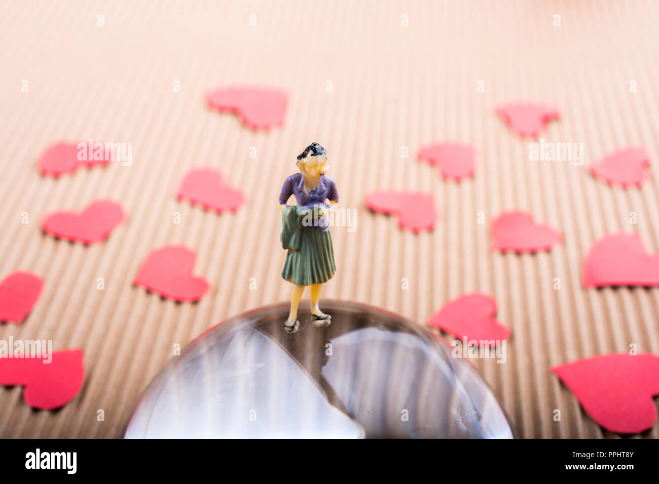 Woman figurine and Love concept with red paper hearts Stock Photo - Alamy