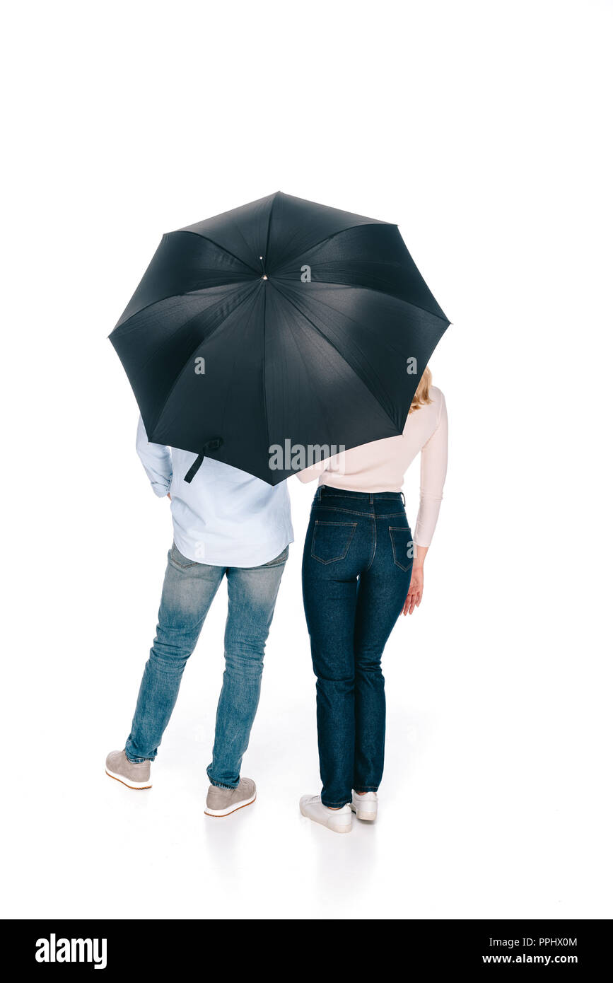 Young people standing under black umbrella hires stock photography and
