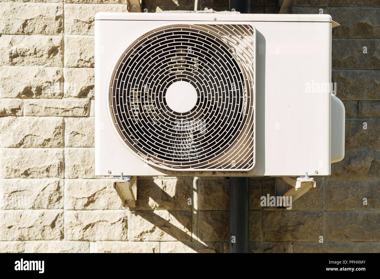 white air conditioner hanging on wall at sunny day Stock Photo - Alamy