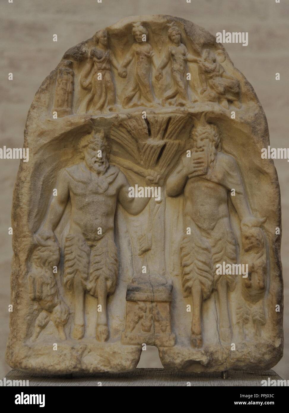 Votive relief for the shepherd god. About 160 AD. Two figures of Pan in a grotto with an altar and a tree between them, above three nymphs, Hermes and a cult pillar of Hecate. Glyptothek. Munich. Germany. Europe.. Stock Photo