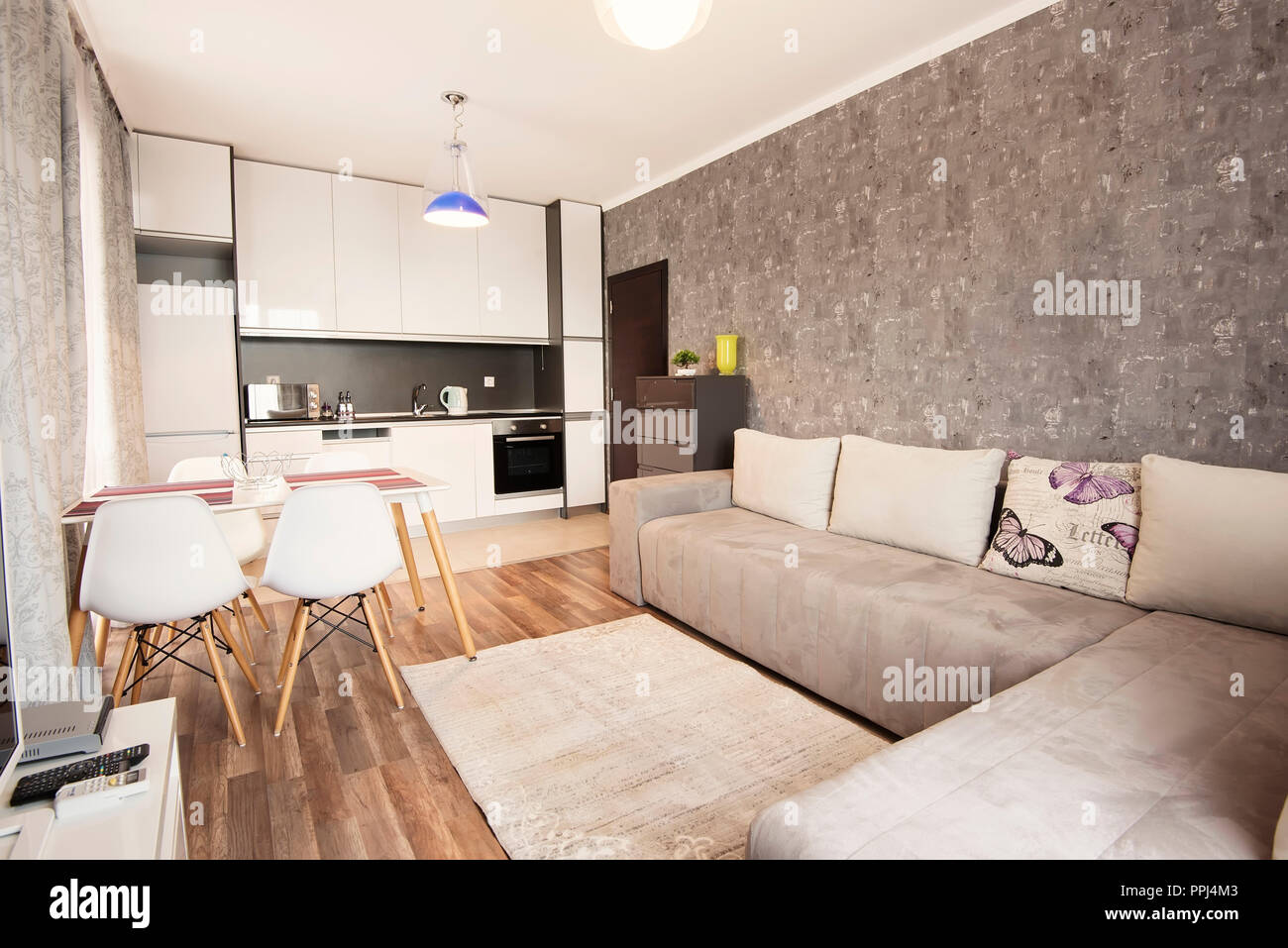 Modern Bright And Cozy Living Room Interior Design With Sofa Dining Table And Kitchen Grey And White Studio Apartment Stock Photo Alamy