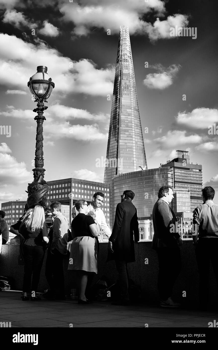 Office workers standing in front of Shard building chatting. Stock Photo