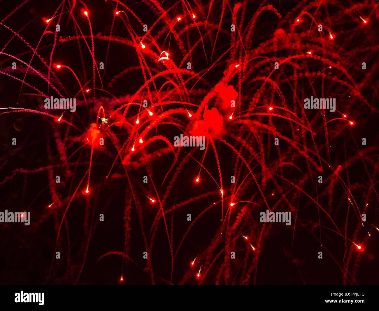 Fireworks blood. The dying fireworks shower the earth with thousands of bright fires Stock Photo