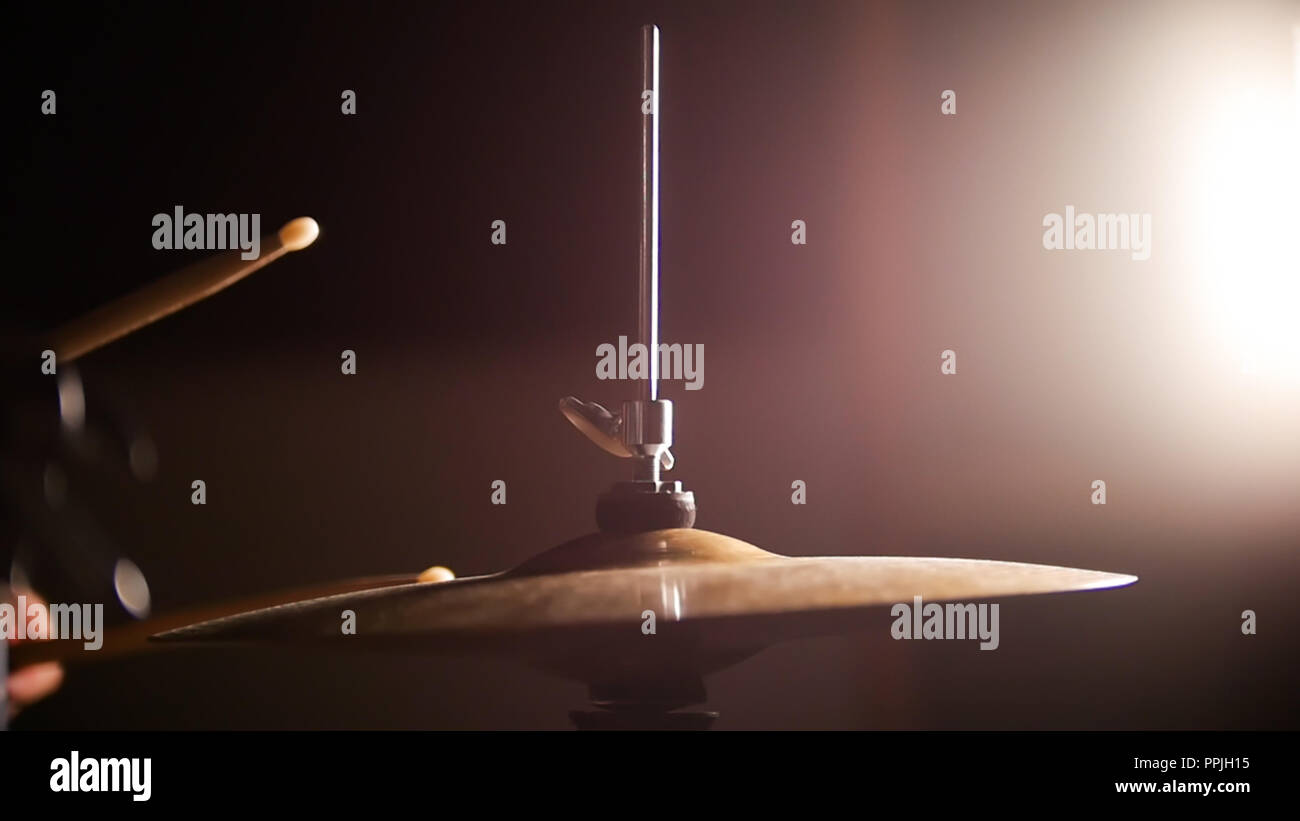 Drum sticks hit the cymbal in the dark studio room Stock Photo Alamy