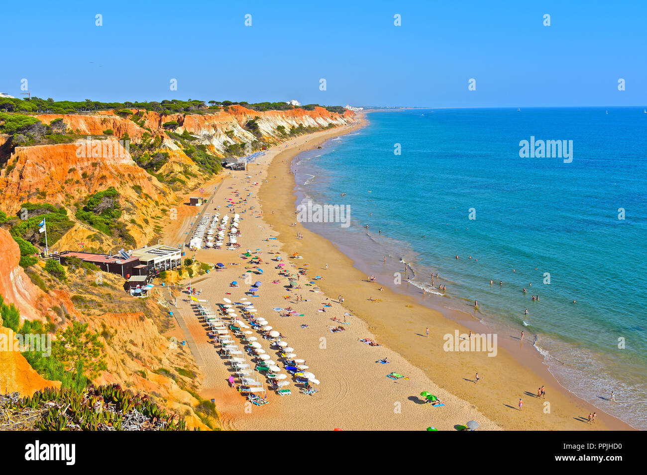 The wonderful golden sandy beach at Praia de Falésia stretches than six kilometres from Vilamoura to Olhos d'Agua, in the Algarve region of Portugal. Stock Photo