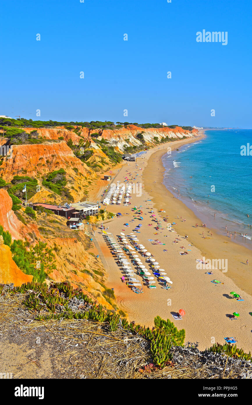 The wonderful golden sandy beach at Praia de Falésia stretches than six kilometres from Vilamoura to Olhos d'Agua, in the Algarve region of Portugal. Stock Photo