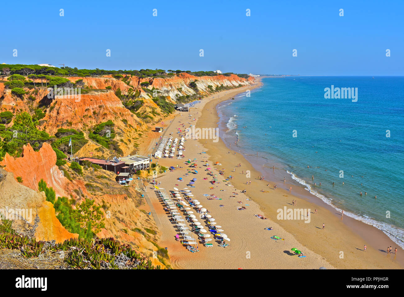 The wonderful golden sandy beach at Praia de Falésia stretches than six kilometres from Vilamoura to Olhos d'Agua, in the Algarve region of Portugal. Stock Photo