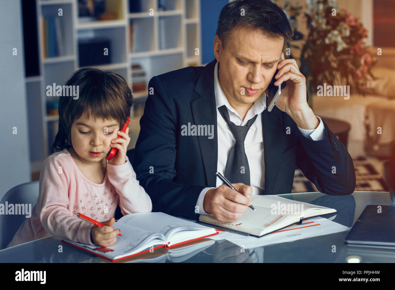 Businessman and his daughter spending time together Stock Photo