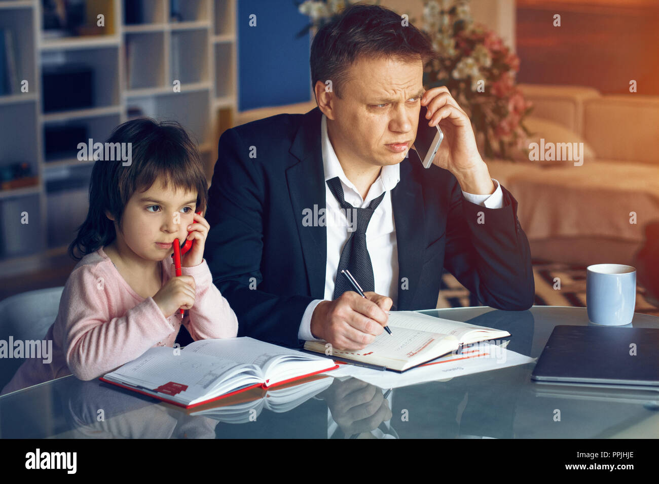 Businessman and his daughter spending time together Stock Photo