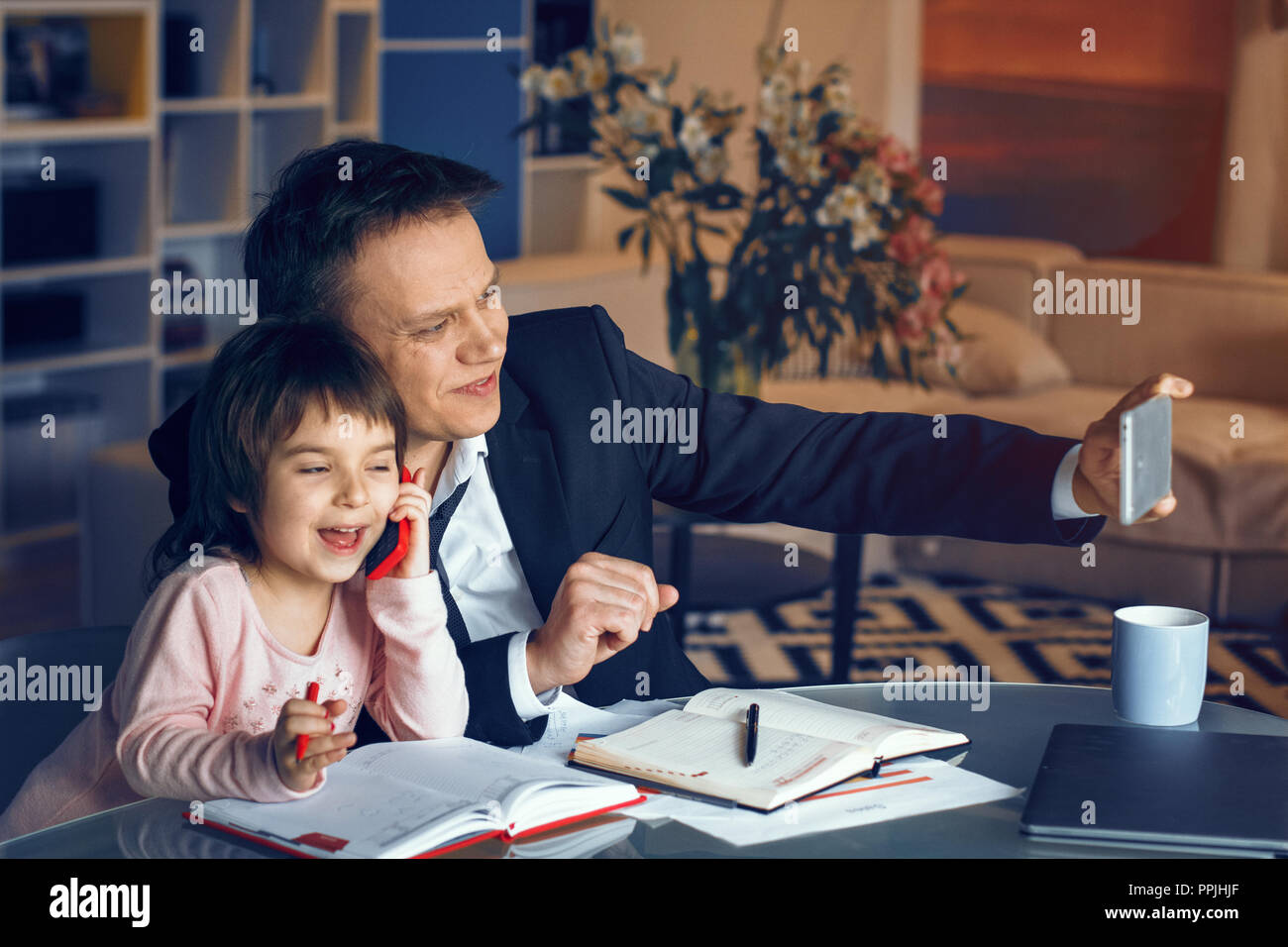 Businessman and his daughter spending time together Stock Photo