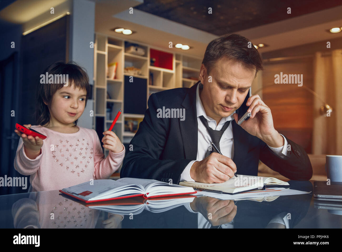 Businessman and his daughter spending time together Stock Photo