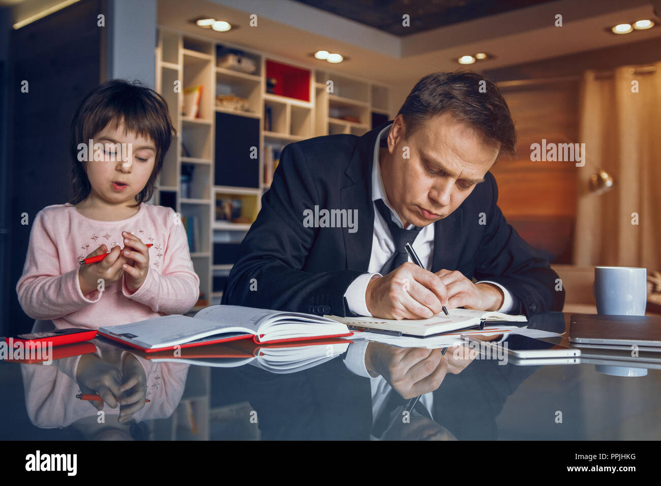 Businessman and his daughter spending time together Stock Photo