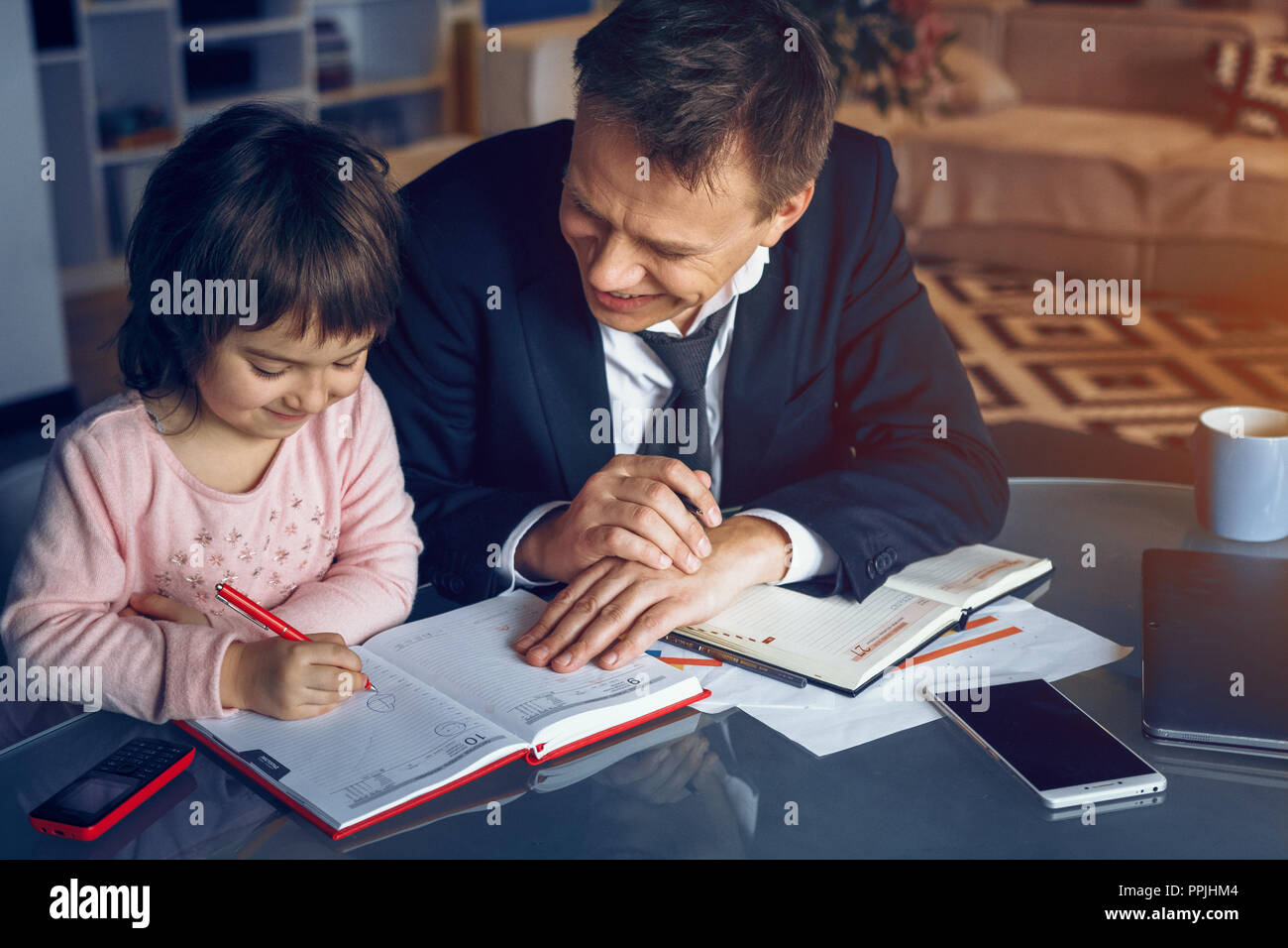 Businessman and his daughter spending time together Stock Photo