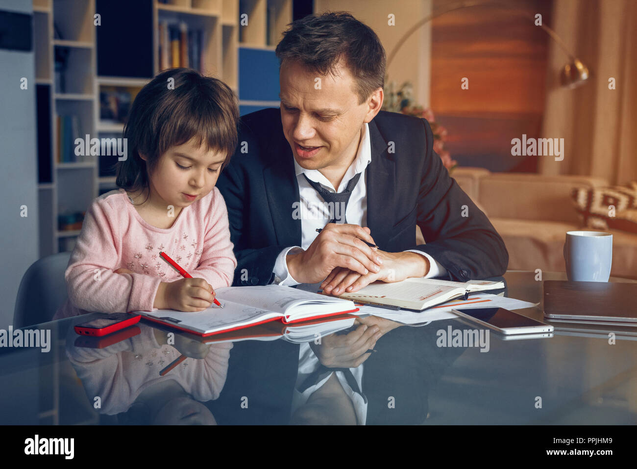 Businessman and his daughter spending time together Stock Photo