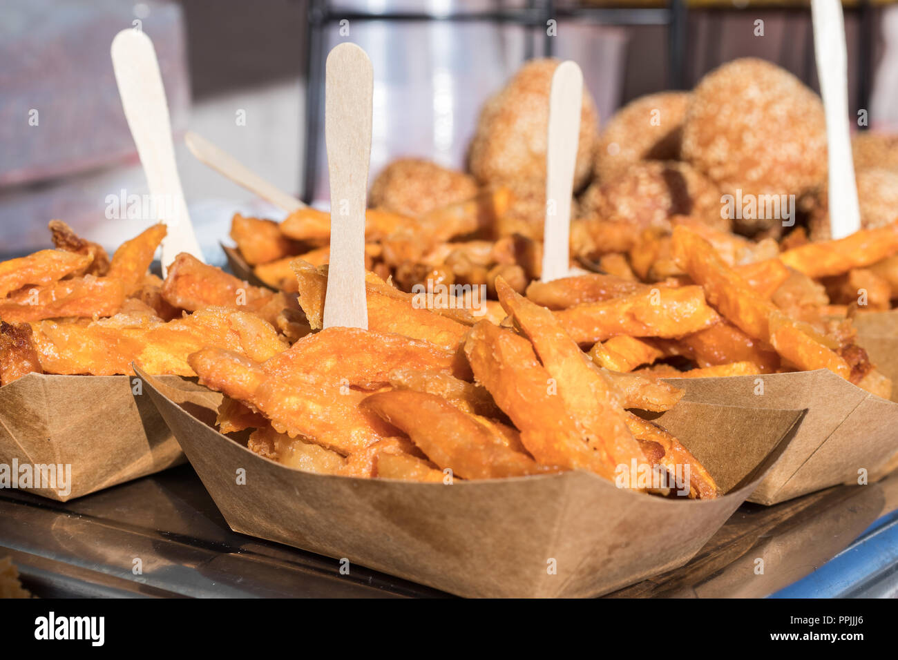 Paper dishes, coasters with portions of sweet potato chips, batatas