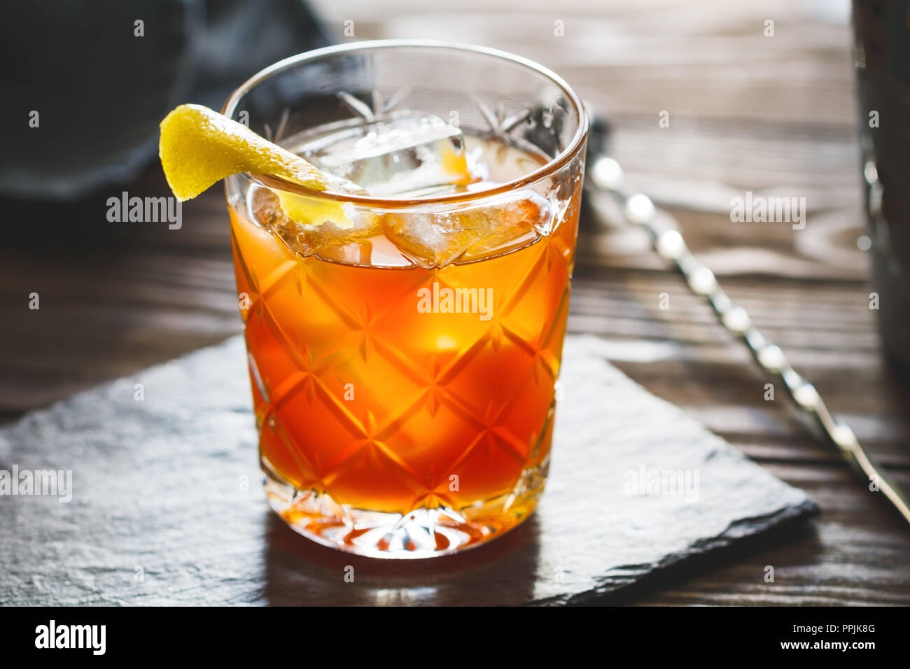 The alcoholic Surfer on Acid cocktail in a old-fashioned glass with a lemon  wedge Stock Photo - Alamy