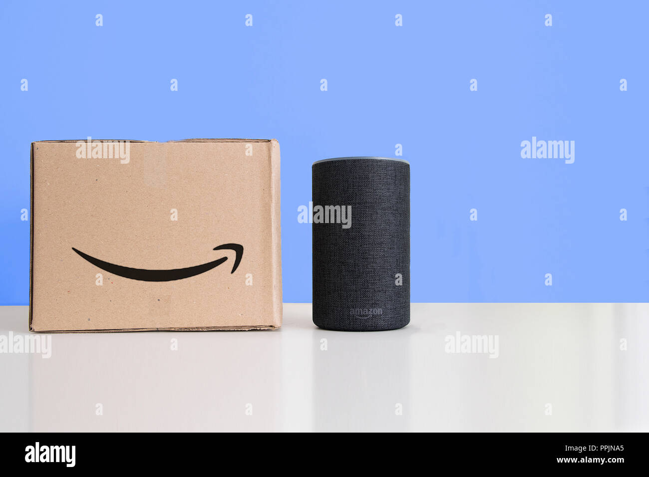 BARCELONA - SEPTEMBER 2018: Amazon Echo Smart Home Alexa Voice Service next to an order in a cardboard box in a living room on September 26, 2018 in B Stock Photo
