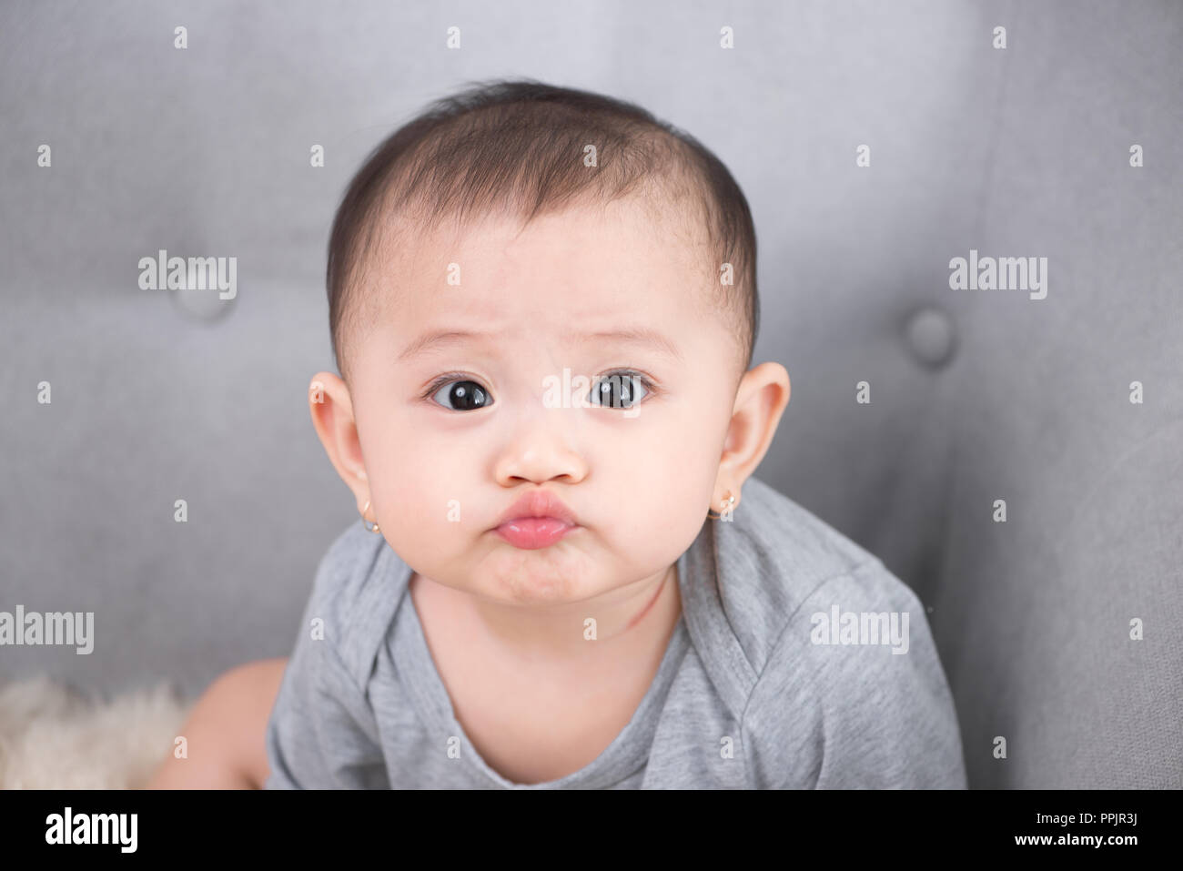 Image of sweet baby girl, closeup portrait of cute 8 month-old smiling girl, toddler. Stock Photo
