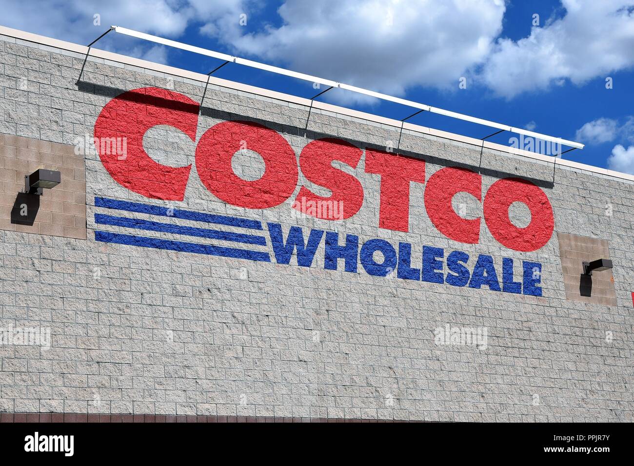 Costco wholesale warehouse sign against a blue sky Stock Photo