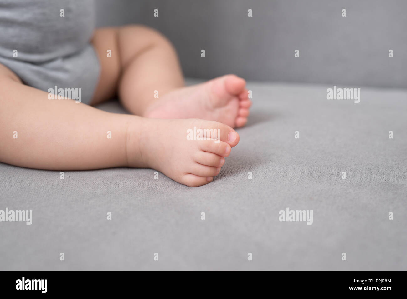Baby's foot on sofa in the room, close up Stock Photo Alamy