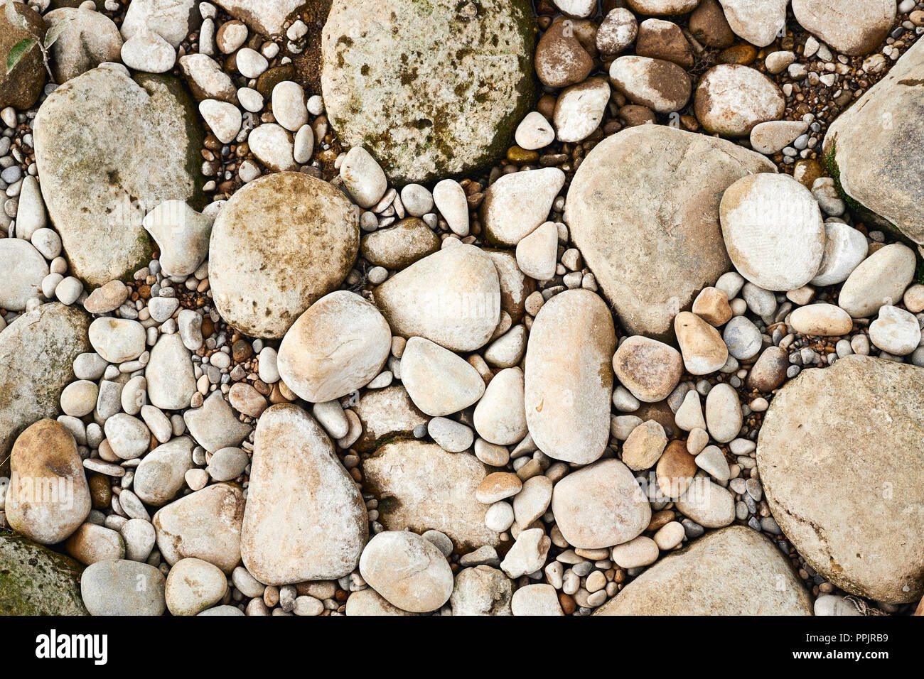 Riverbed pebbles, warm tone background image. Stock Photo