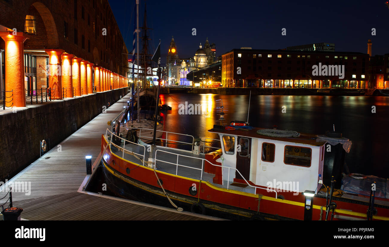 The Albert Dock at night, with The Three Graces in the background, including The Liver Building, Cunard and Dock Board Building. Taken September 2018. Stock Photo