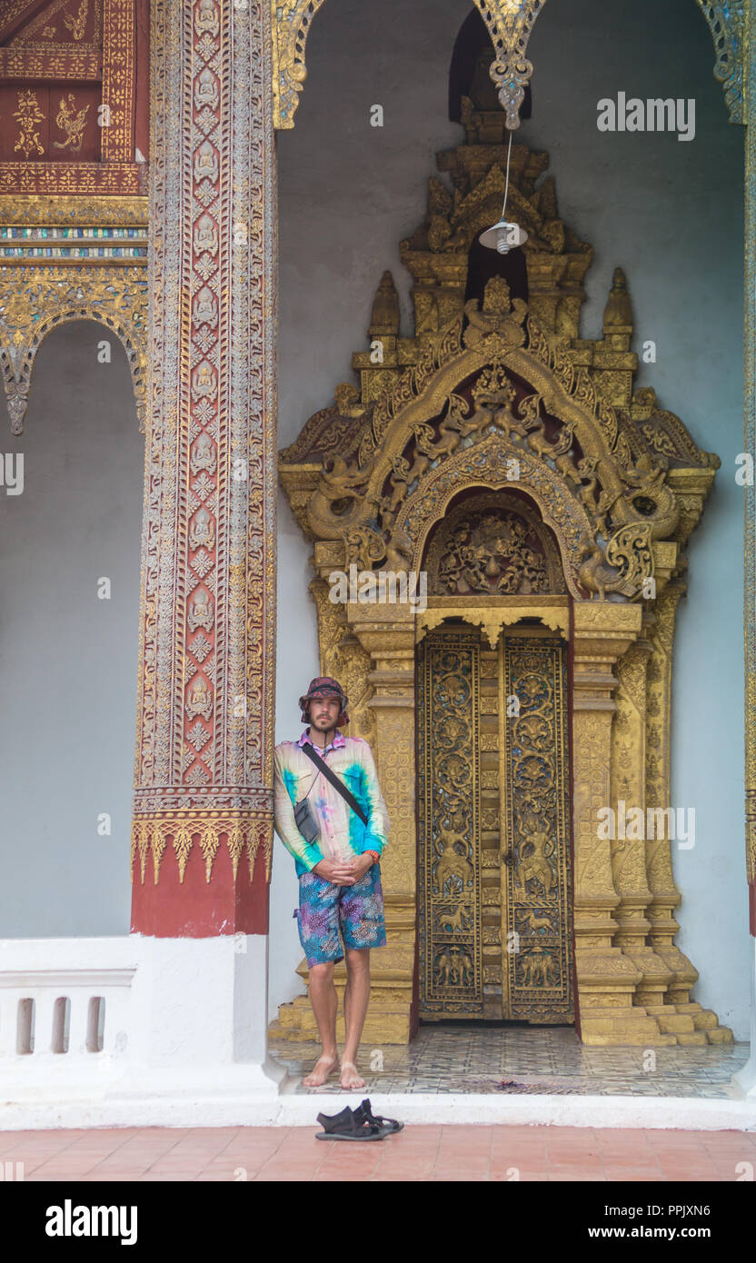 tourists posing in front of temple in koh samui thailand shot with selective focus and lens flare Stock Photo