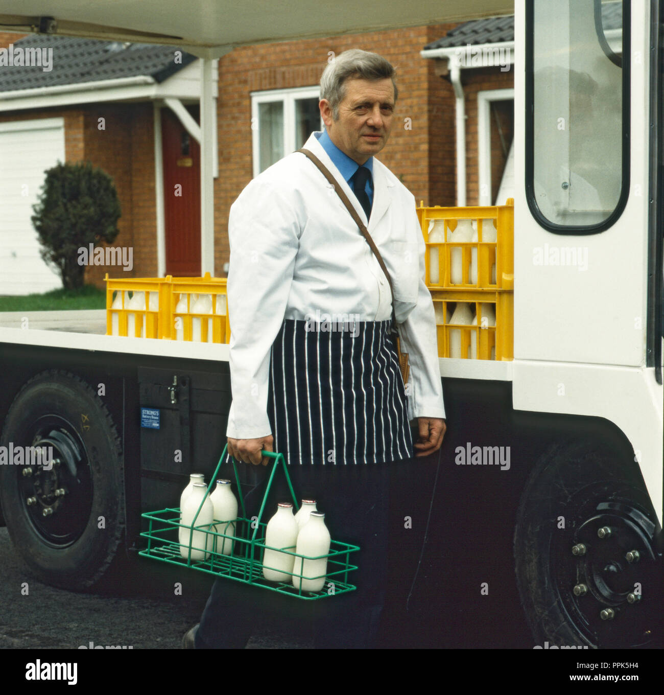 Doorstep Milk Delivery With Milkman And Milk Float Stock Photo Alamy   Doorstep Milk Delivery With Milkman And Milk Float PPK5H4 