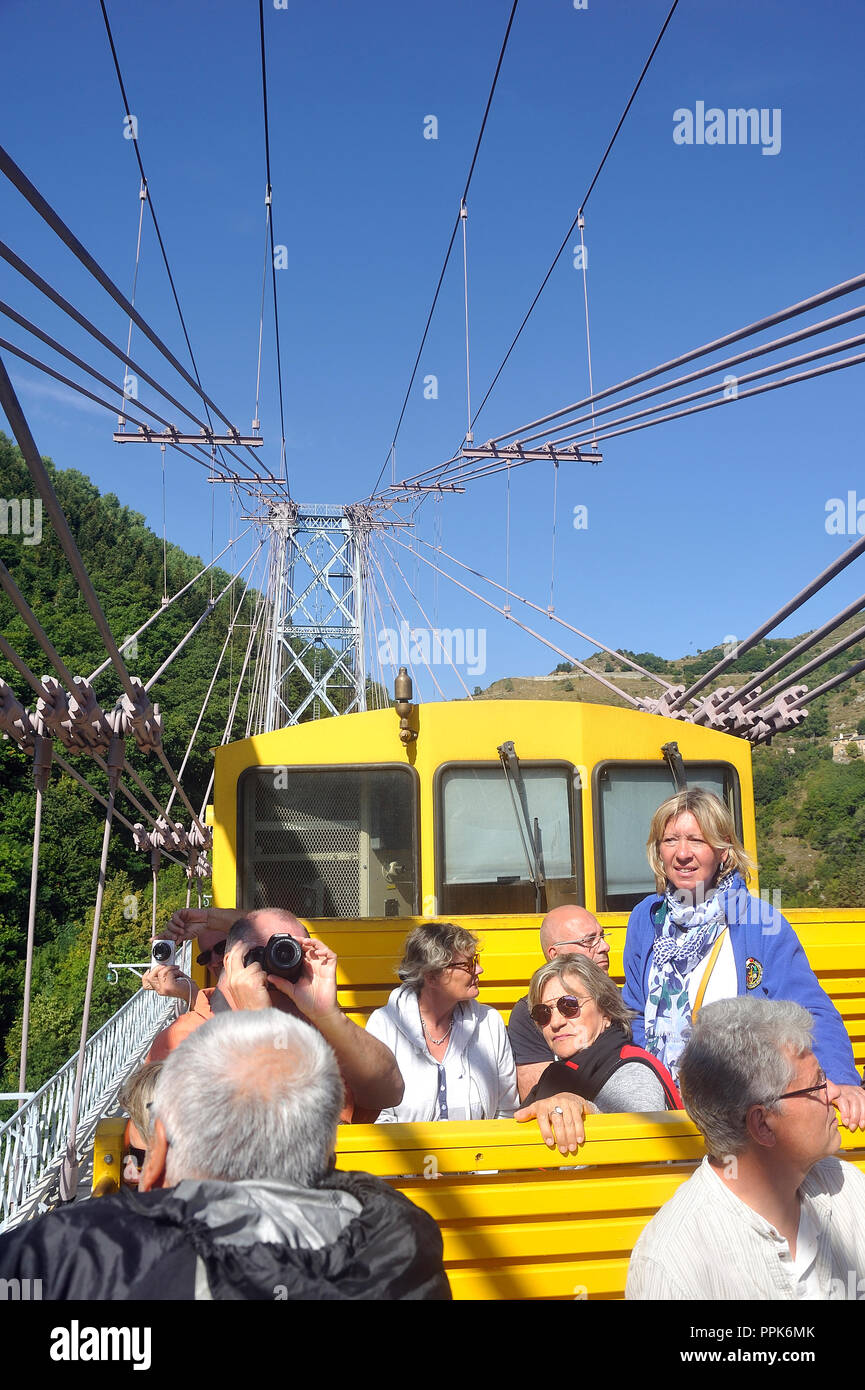 The travelers of the little yellow train of the Pyrenees in the wagon in the open air Stock Photo