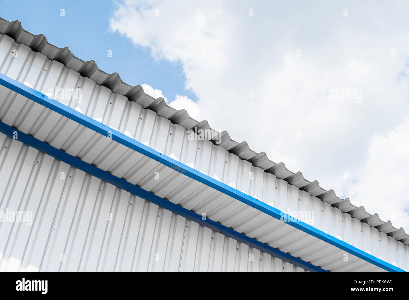 Industrial construction of Metal white sheet and blue corners. Roof sheet  metal or corrugated roofs of factory building or warehouse Stock Photo -  Alamy