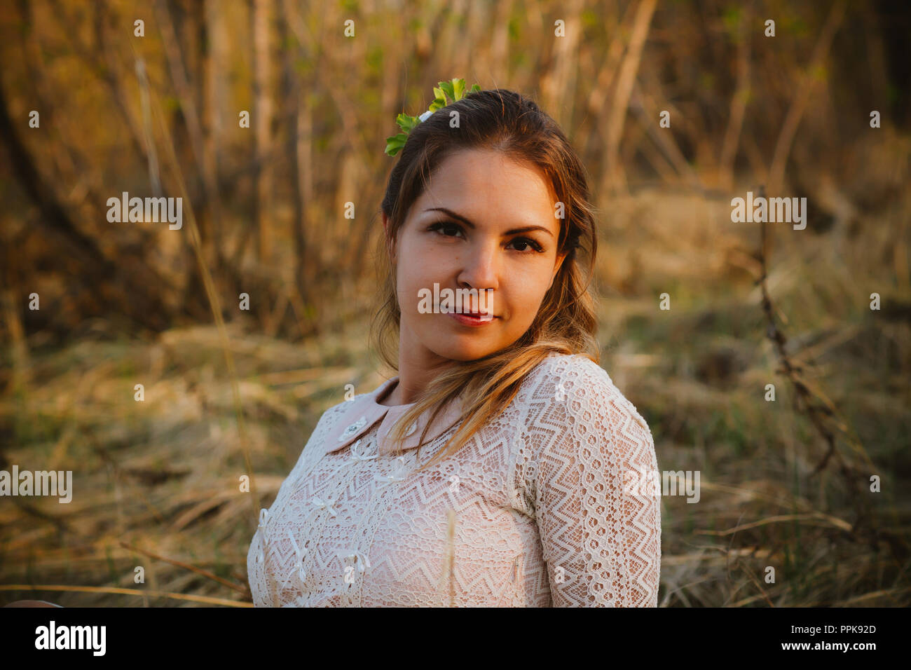 girl is sitting in the field on the sunset background Stock Photo - Alamy
