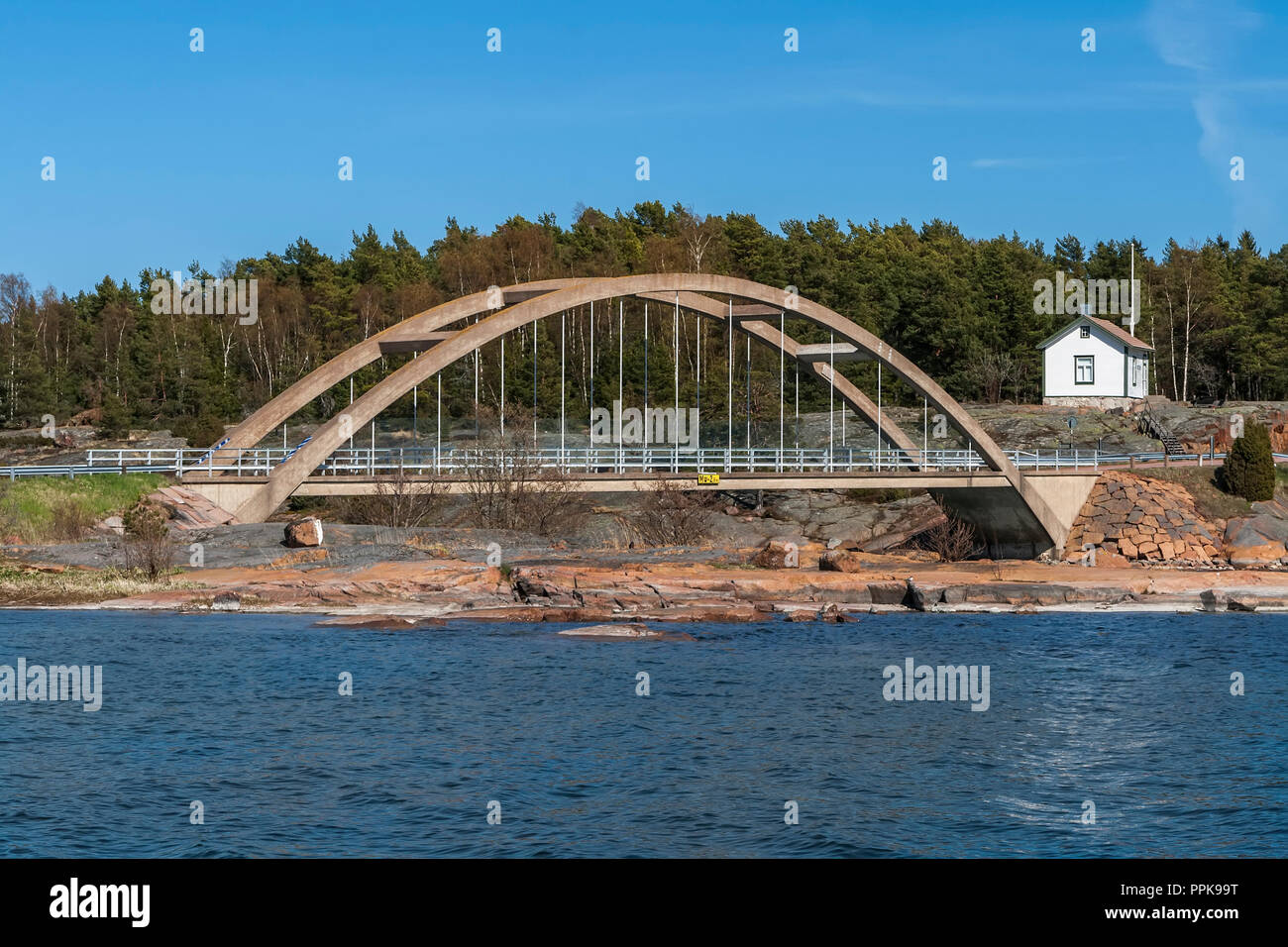 Arch bridge across the strait between the islands of the Aland Stock Photo