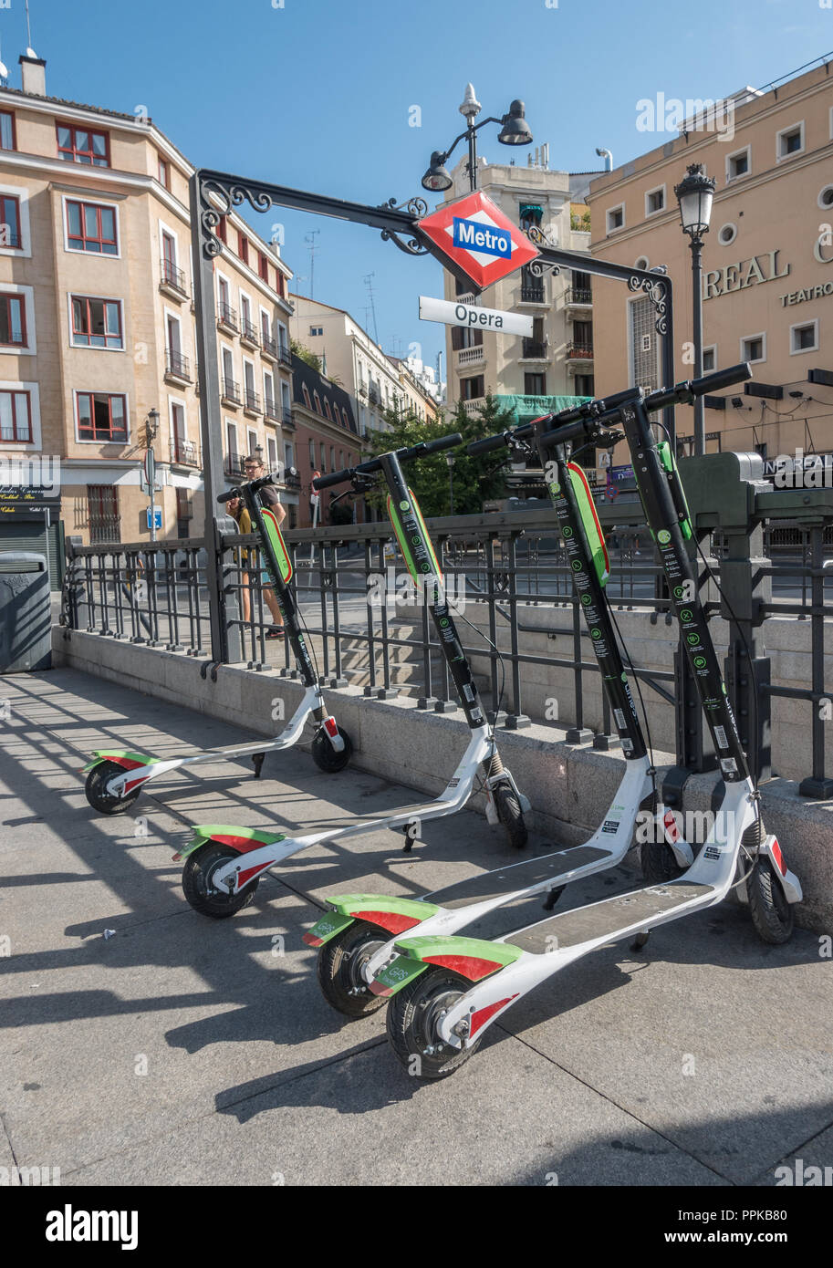 Lime Electric scooters parked in Plaza de Isabel II, Madrid, Spain