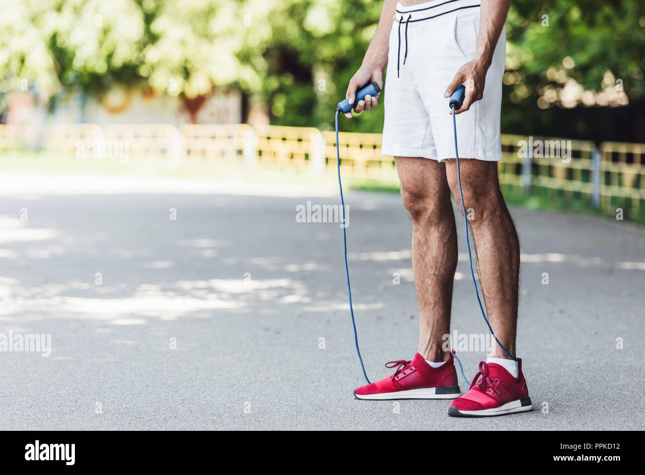 cropped shot of sportive young man with jumping rope Stock Photo
