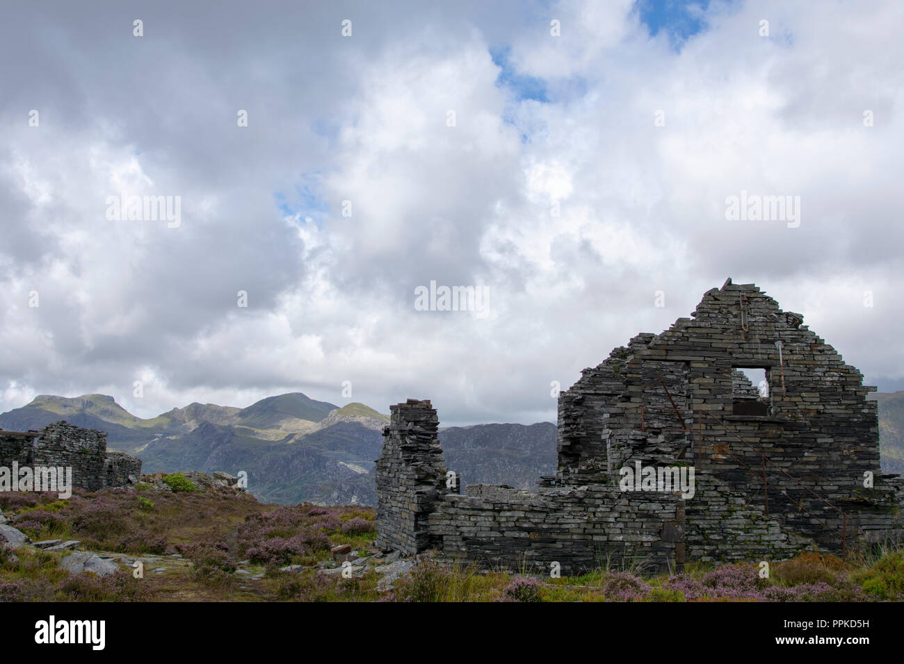 Abandoned slate working buildings at the top of  Llechwedd Quarry looking towards Moelwyn Mawr and Moelwyn Bach hills Stock Photo