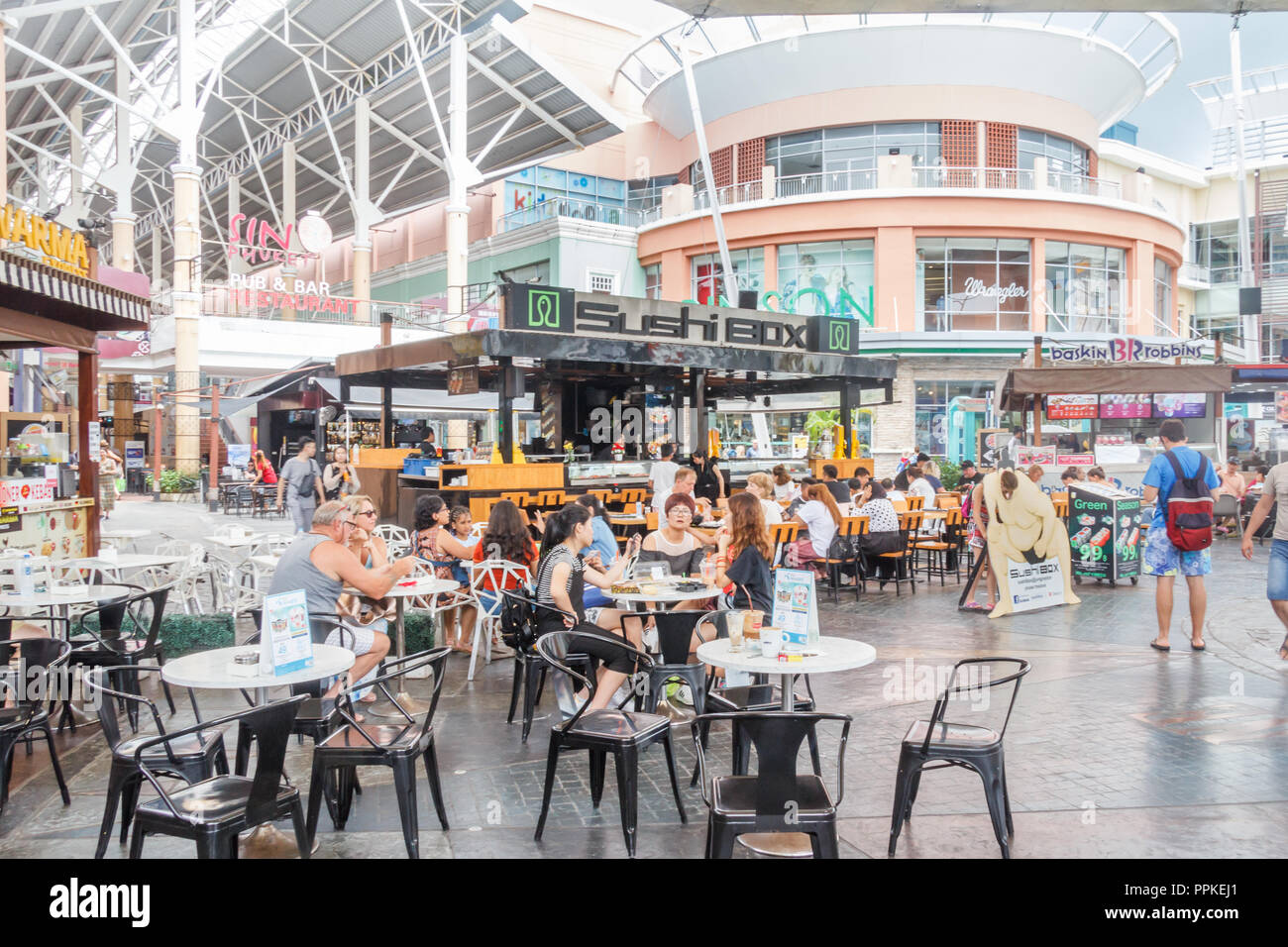 Patong, Thailand - 9th August 2018: People sat outisde the Sushi Box restaurant in Jung Ceylon shopping mall.  The mall serves mainly holidaymakers. Stock Photo