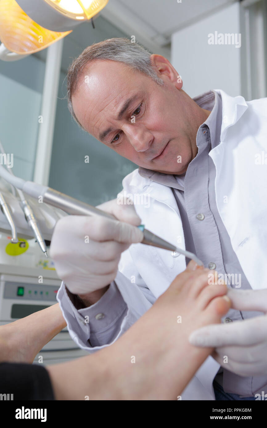 doctor removing something from the toenail Stock Photo Alamy
