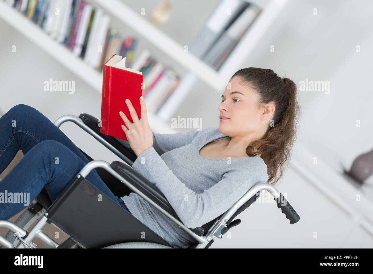 girl in wheelchair with a book Stock Photo Alamy