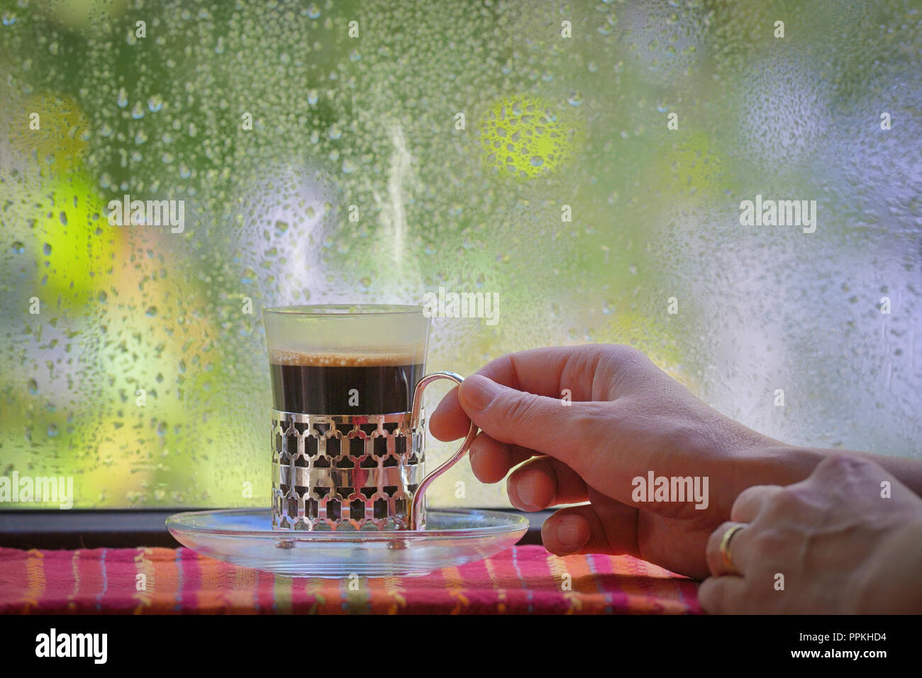 Fresh turkish coffee cup at rainy window Stock Photo
