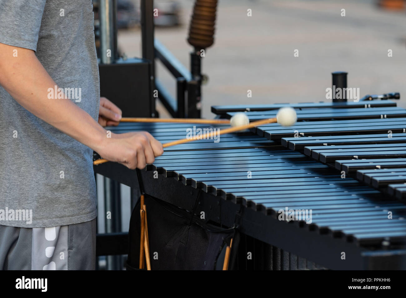 a sideline percussionist rehearsing on his vibraphone at marching band rehearsal Stock Photo