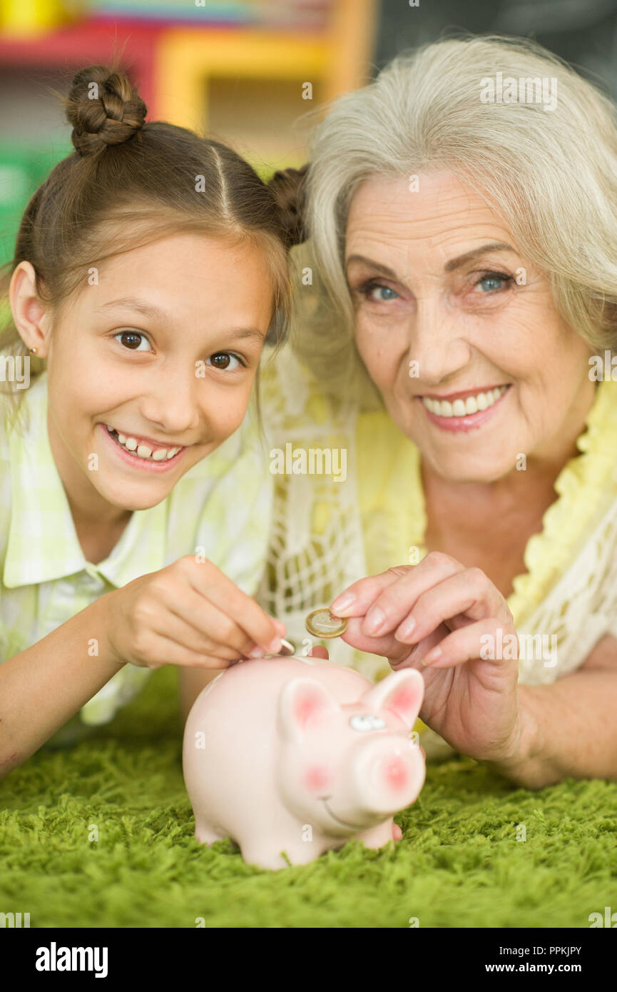 Portrait of old woman with piggy bank Stock Photo - Alamy