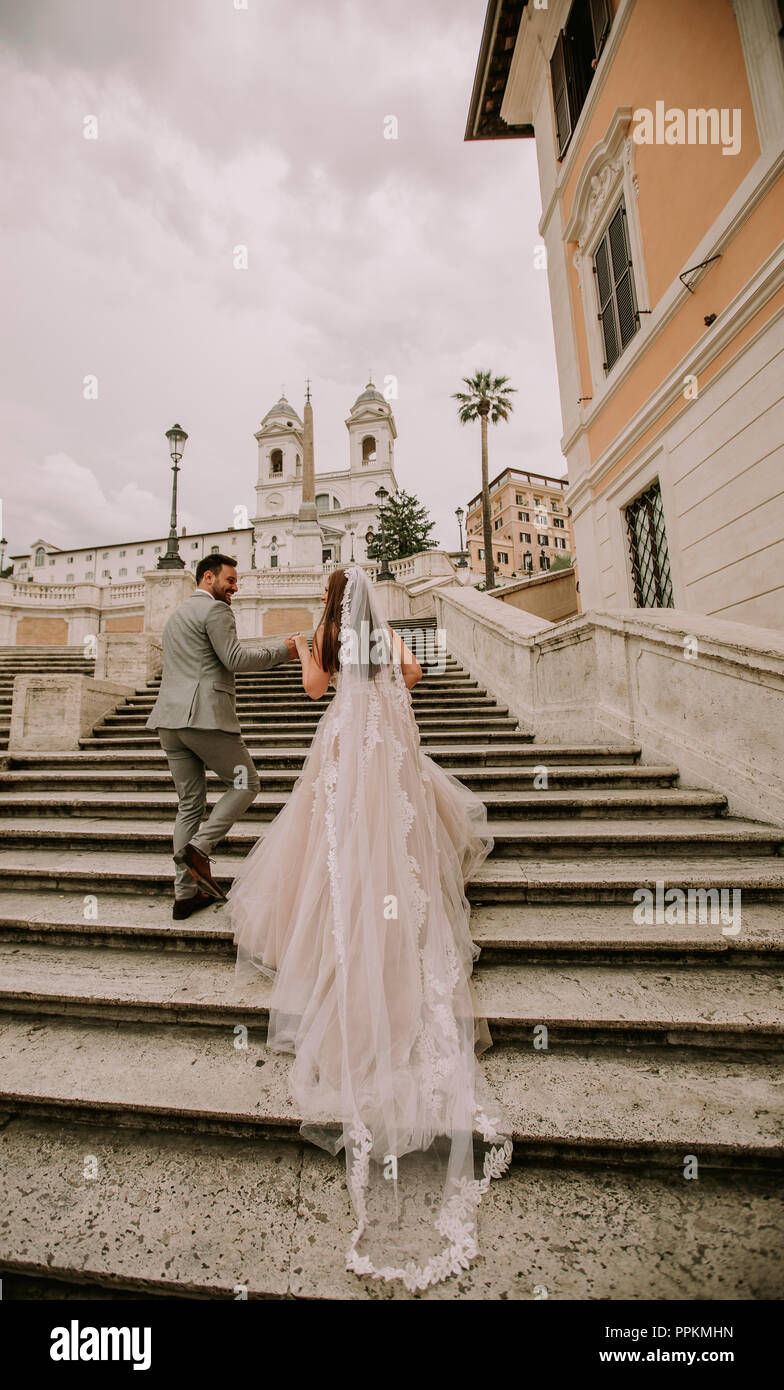 Young Wedding Couple On Spanish Stairs In Rome Italy Stock Photo