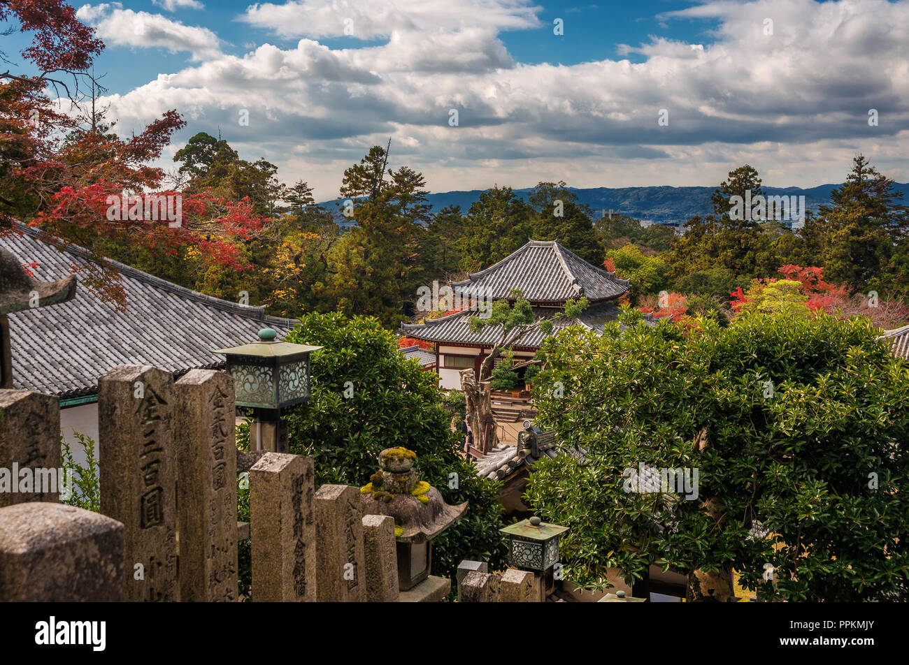 Ancient temples among trees in Nara Park Stock Photo
