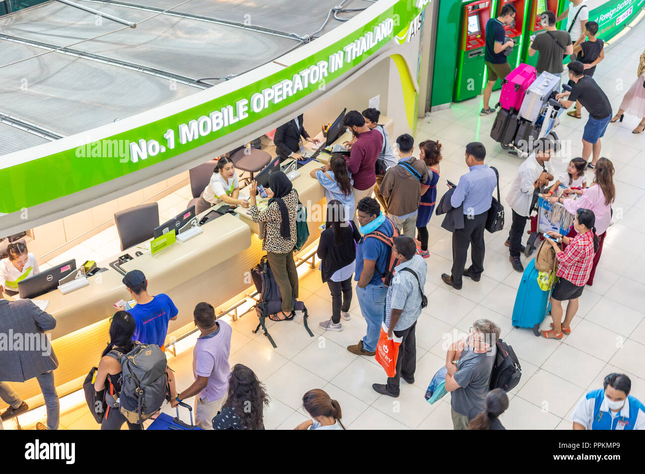 BANGKOK, THAILAND - July 21 2018 - International tourists and travelers get in line to purchase phone sim card at Suvarnabhumi International Airport i Stock Photo
