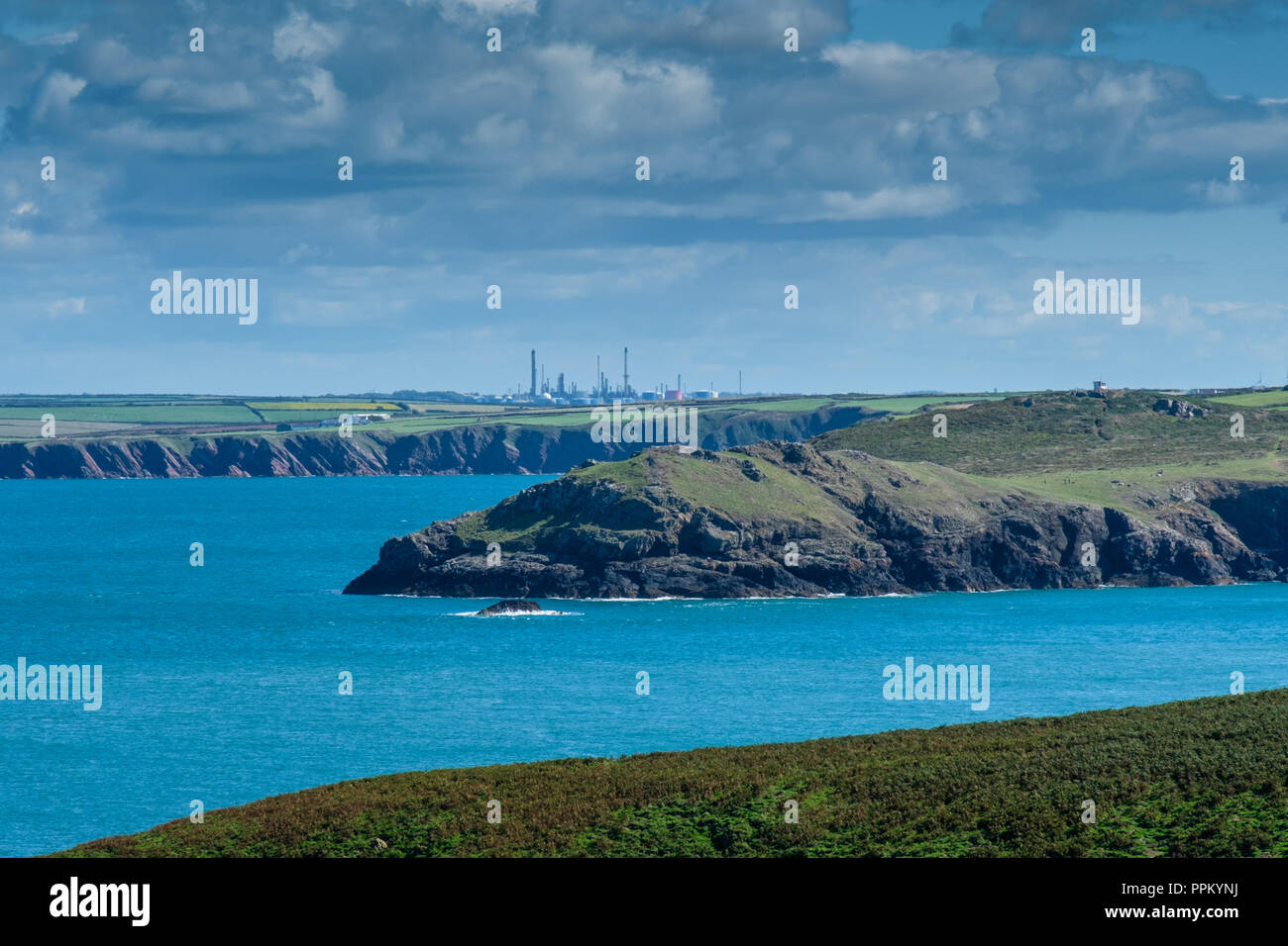 Oil refinereies at Milford Haven seen from Skomer Island, Pembrokeshire, Wales Stock Photo