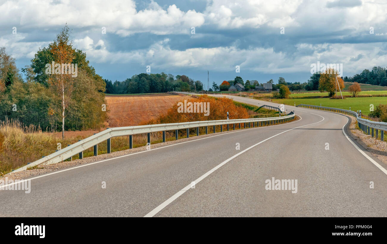 Autumn landscape with asphalt road and forest Stock Photo - Alamy