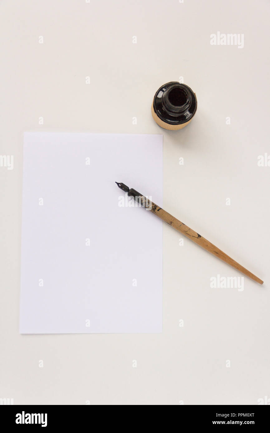 An old nib pen, a bottle of black ink, a sheet of paper with place for ...